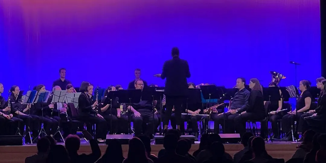 The Wind Ensemble performs onstage in Roone Auditorium.