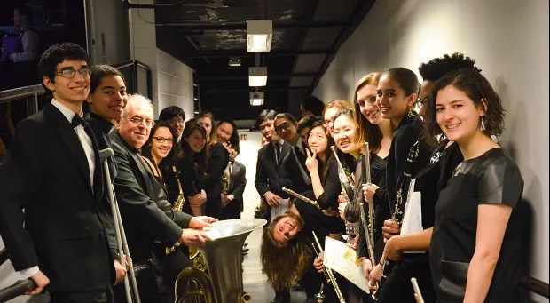 CUWE members line up down the hallway and pose for a picture.
