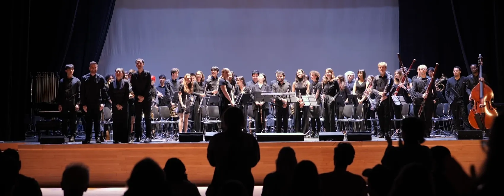 CUWE members take a bow onstage after a Festival of Winds performance.