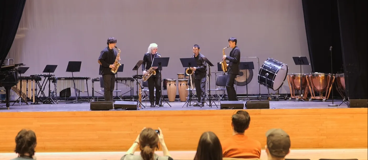 Four chamber musicians perform onstage.