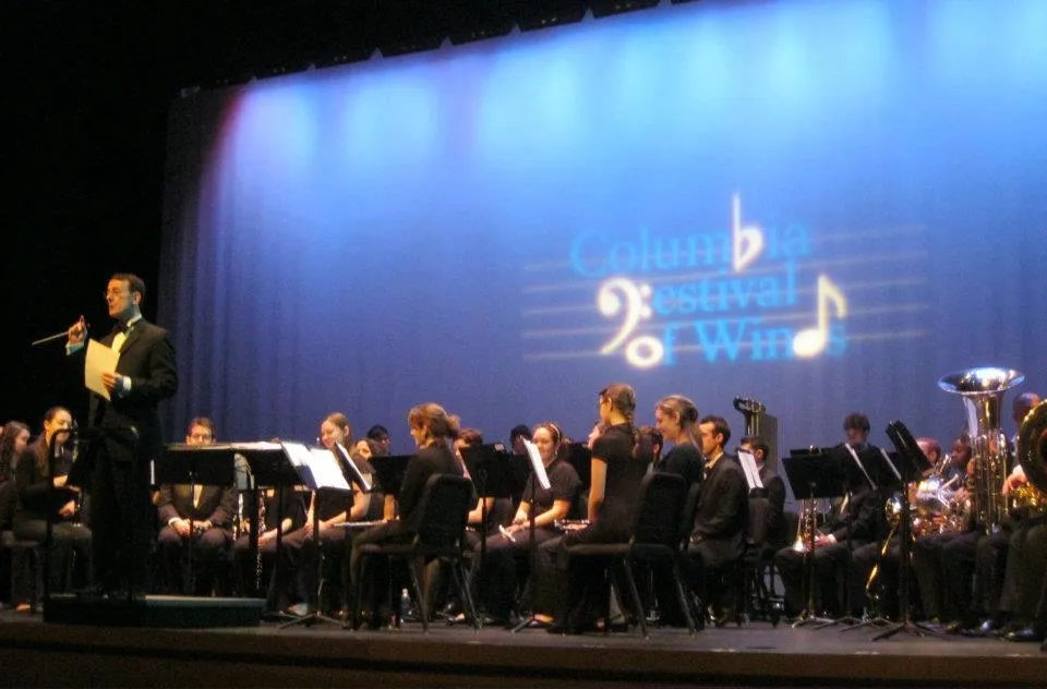The conductor speaks to the crowd from onstage at a past Festival of Winds event.